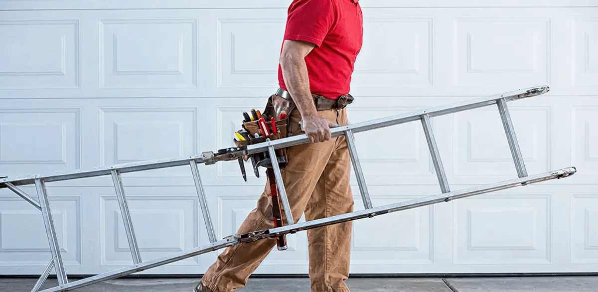 Garage door repair technician arriving with tools and ladder in Sterling Heights, MI