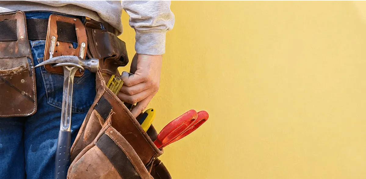 Handyman with tool belt ready for home repairs and maintenance in Sterling Heights, MI